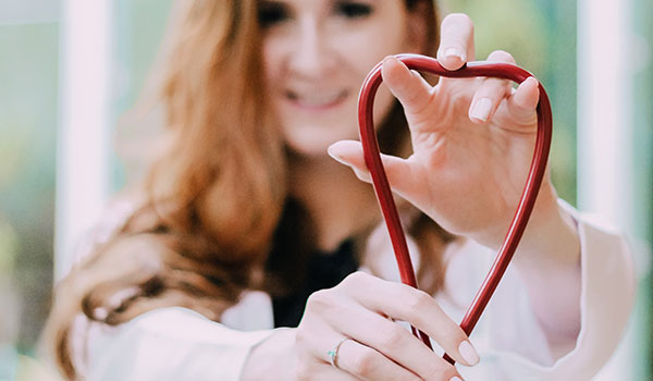 photo of woman holding red stethoscope 3408368 - NHS is open! Don’t delay – call your GP with any health worries